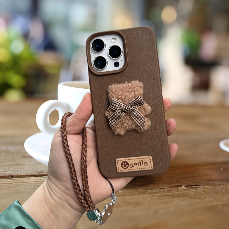 A Single-Pack Plush Teddy Bear Phone Case with a Bow, Available in White And Brown. It Comes with a Wrist Strap And Features a Simple And Elegant Faux Leather Texture That Is Anti-Slip And Fingerprint-Resistant. Made with TPU
